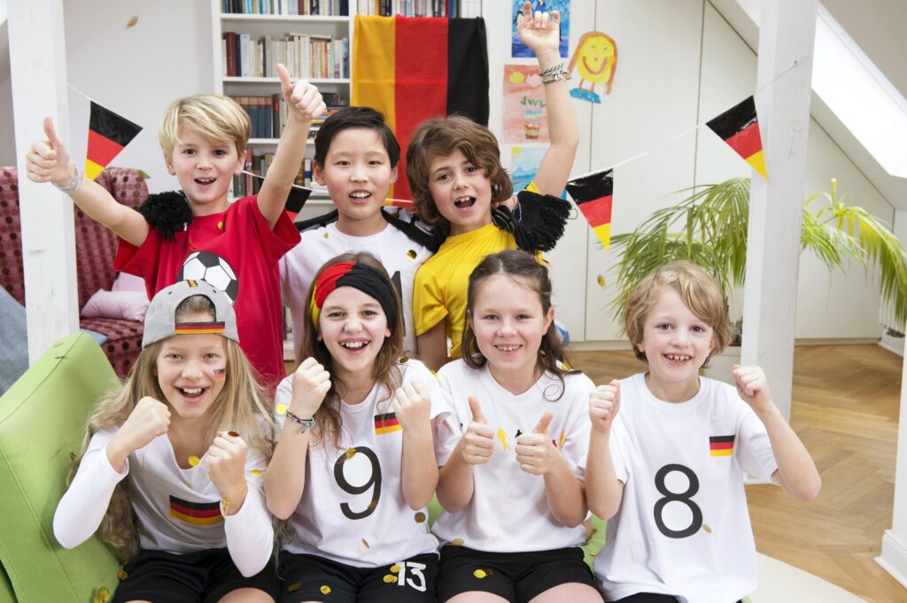 Group of kids watching soccer world championship, cheering